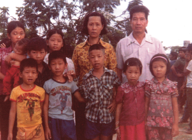The Cau family the day they left a Thai refugee camp for Canada. Peng is in the front, second from right, standing next to a friend. The Cau children’s colourful outfits (gifts from a refugee couple who “had nothing”) were a welcome change from their former black uniforms.